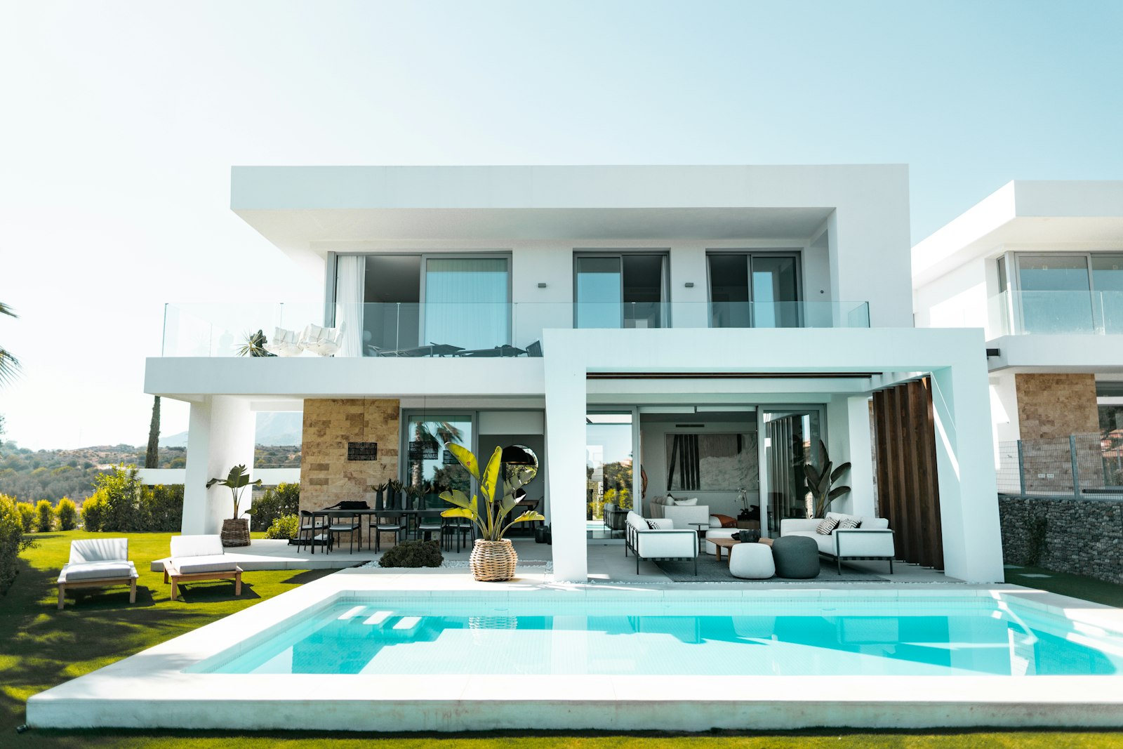 Modern white Mediterranean villa with a pool in Cyprus, captured by drone