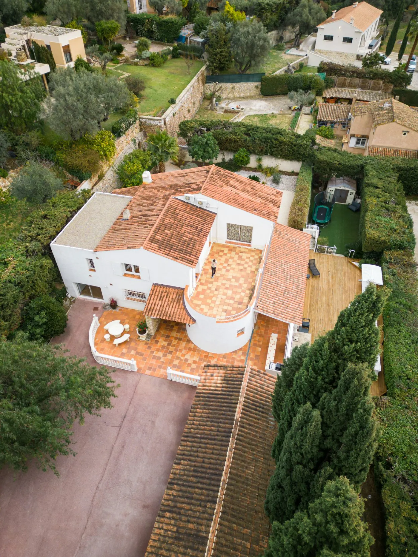 Aerial drone view of a Mediterranean villa with terracotta roof and terrace
